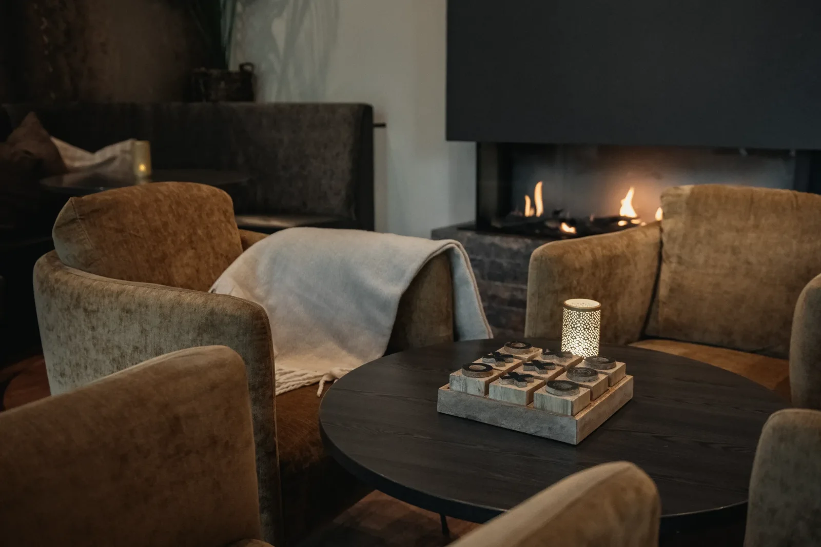Seating area by the fireplace in The Gate Bar